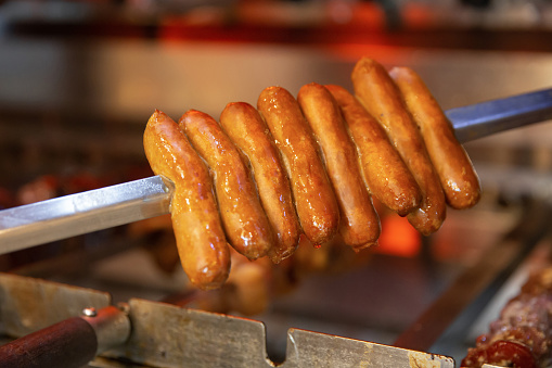 Close up shot of stacks chicken sausage on bbq skewer
