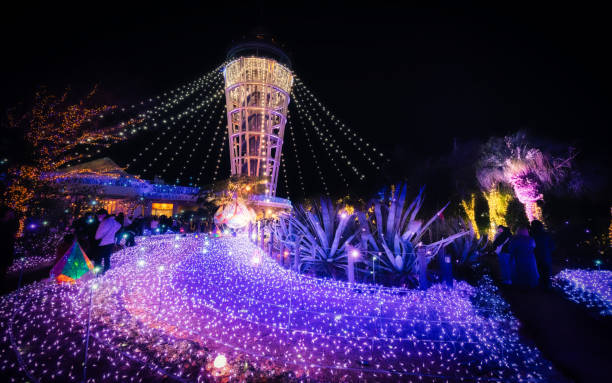 Kanagawa,Fujisawa, Japan - December 18 2022  \nThis photo was taken on Enoshima, a representative island in Kanagawa Prefecture. Every December, Enoshima lights up with illuminations, attracting numerous tourists. The photo was captured within the Samuel Cocking Garden, a unique garden on Enoshima, and is distinguished by a distinctive lighthouse.