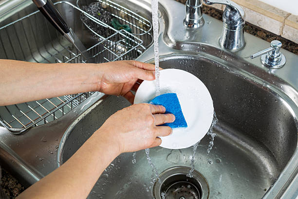 istock Female hands washing single white dinner plate 179142093