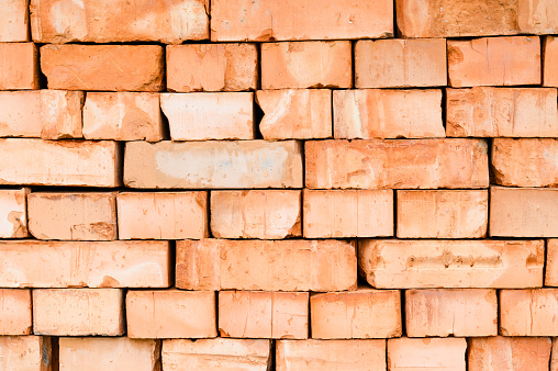 Textured background of stacked orange bricks