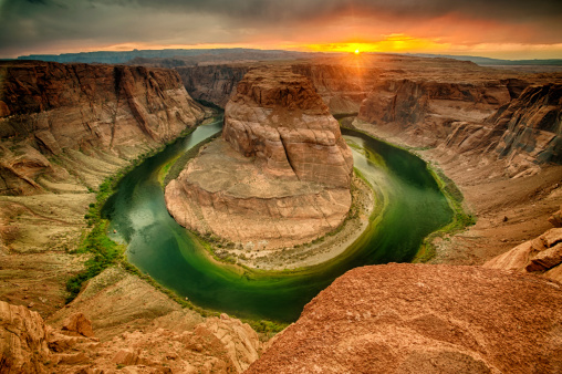 The Grand Canyon at Horseshoe bend in Page, Arizona at sunset in the summer where the Colorado River is green