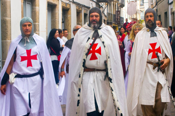 Reenactment Templar Knights. Medieval Festival Historical reenactment, templar knights. Medieval Festival ,period clothings, parade along the street . Mondoñedo medieval historical reenactment. Lugo province, Galicia, Spain. knights templar symbols stock pictures, royalty-free photos & images