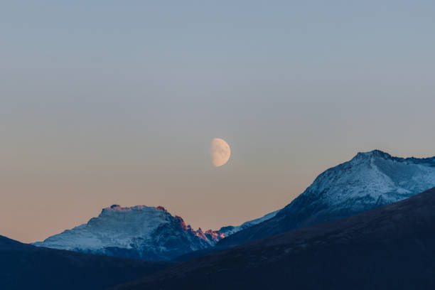 istock Big Moon in Pink Polar Sky Above Snowcapped Mountains 1791429182