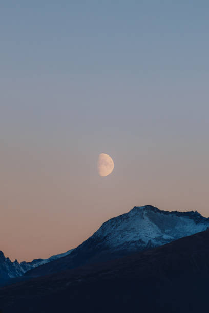 istock Big Moon in Pink Polar Sky Above Snowcapped Mountains 1791431753