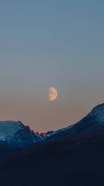 istock Big Moon in Pink Polar Sky Above Snowcapped Mountains 1791432949