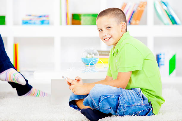 istock Boy sitting on the living room floor 179143918