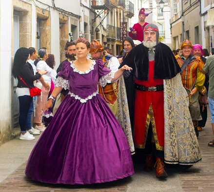 Historical reenactment. Medieval Festival King and Queen characters ,period clothings street artists parade along the street .  Mondoñedo medieval historical reenactment. Lugo province, Galicia, Spain.