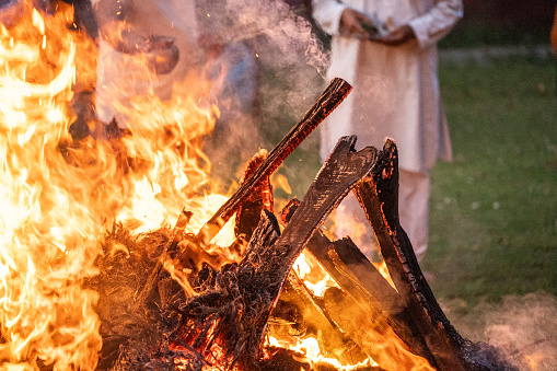 Fire burning with wood sticking out showing funeral pyre in Hindu Religion showing death in India