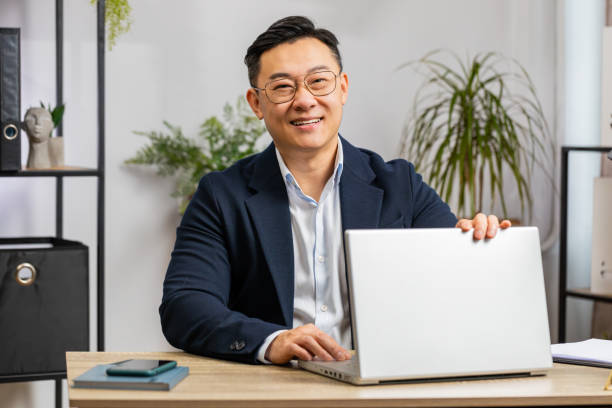 istock Asian businessman freelancer at office workplace working on laptop computer sends online messages 1791503793