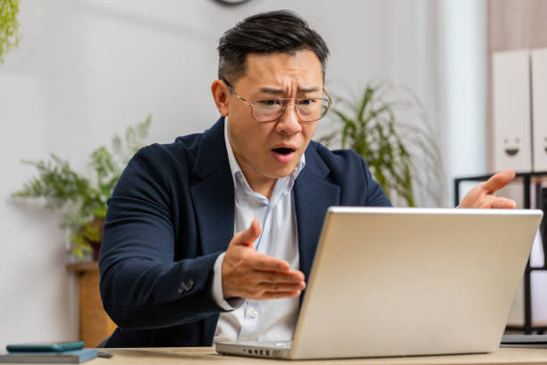 istock Irritated tired businessman working on laptop website problem, computer virus data loss by hacking 1791504365