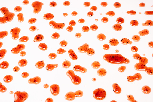 Red jam splashes isolated on a white background. Top view.