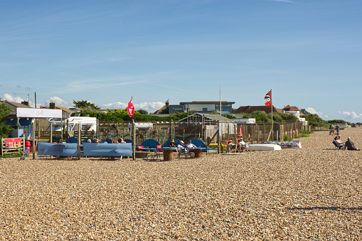 Small beach cafe at East Preston near Littlehampton in West Sussex, England. With people sitting in sunshine.