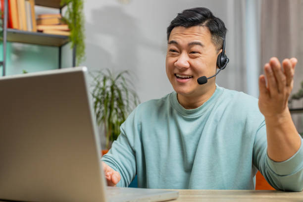 istock Asian man freelance worker call center or support service operator helpline having talk with client 1791525805
