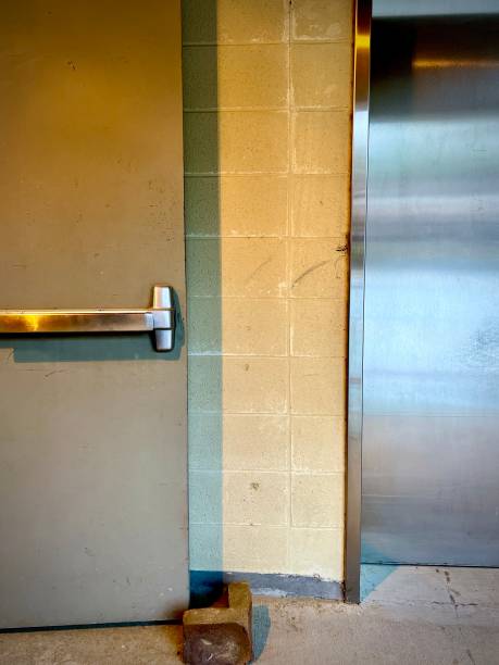 istock Block wall, closed elevator door and exterior grade door 1791532850