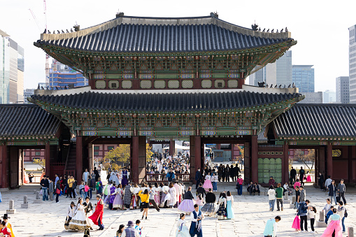 seoul, south korea - october 22, 2023: people at the gyeongbokgung palace. the people wearing traditional hanok clothing and enjoying the entire palace place.