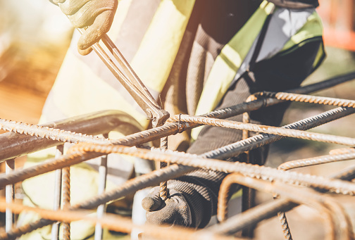 Construction worker steel fixer working at the building  site close-up