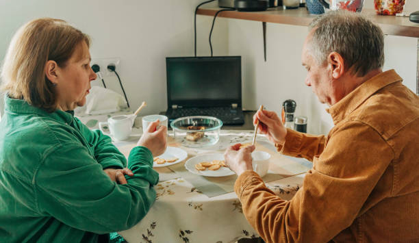 istock elderly couple sitting at a table and having lunch 1791546823