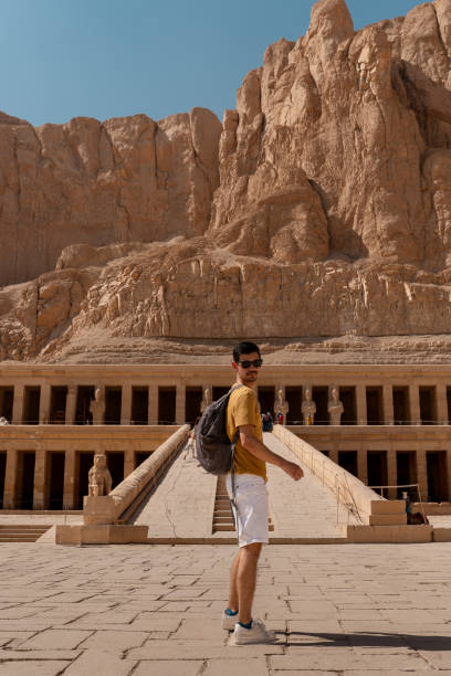 istock young man visits Hatshepsut temple in Luxor. Egypt 1791549485