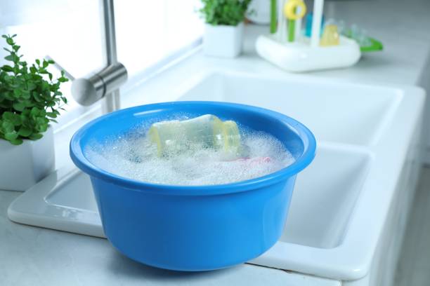 istock Light blue basin with baby bottles on white countertop in kitchen 1791558412