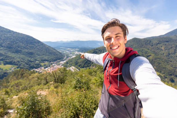 istock Man taking a selfie video, mountain panorama in the background 1791560626
