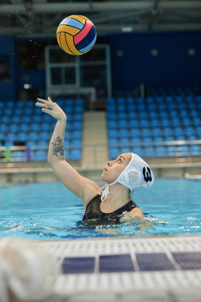 istock Young active female water polo player throwing ball over herself 1791563996