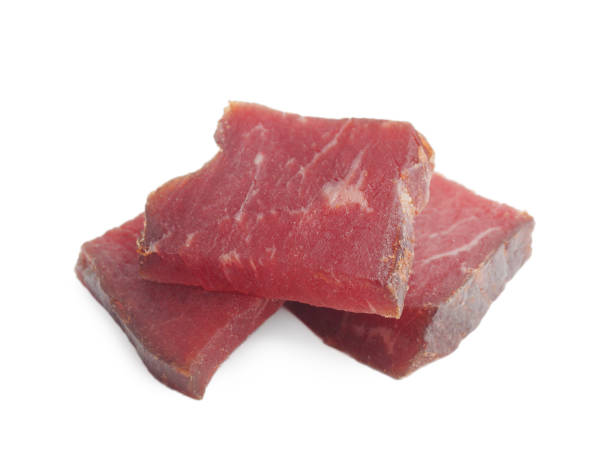 istock Pieces of delicious beef jerky on white background 1791571155