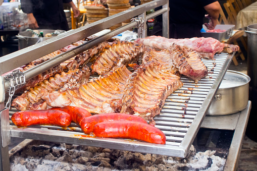 Barbecue grill, pork chop, chorizos, sausages, prepared in a market stall. Medieval Historical Reenactement. Mondoñedo,Lugo province, Galicia, Spain.