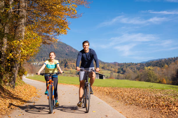 istock Couple cycling on a forest trail, holding hands and having fun 1791586831