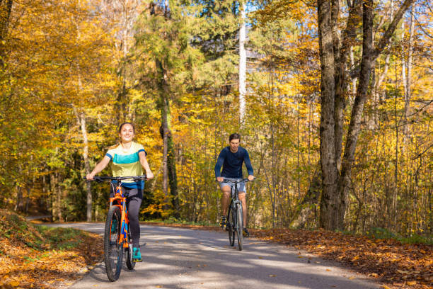 istock Couple cycling on a forest trail, holding hands and having fun 1791586838