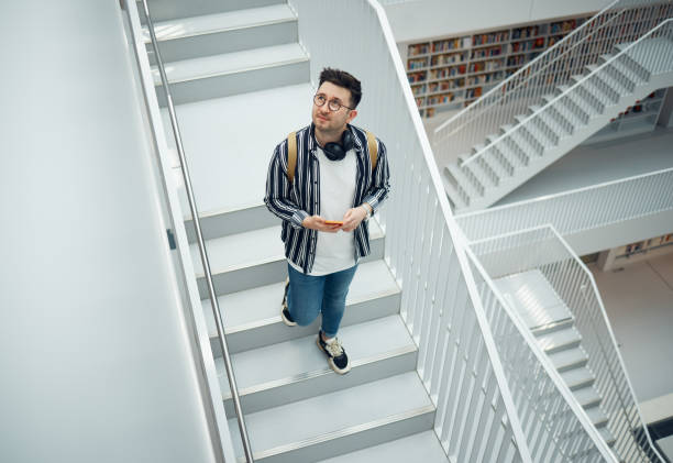 Young woman is walking downstairs in office building