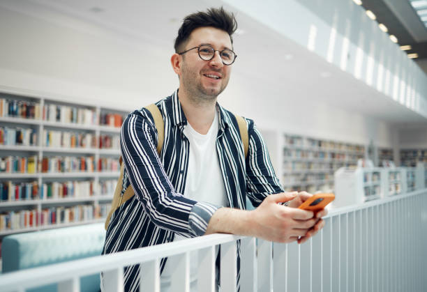 istock Library, smart student or intelligent man with phd research goals, vision for success and excited for knowledge learning. University, campus or college people thinking of books in education and study 1791587417