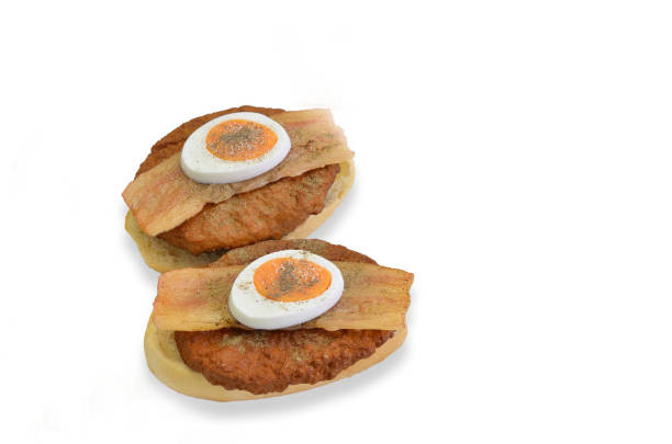 two sandwiches with beef, bacon and egg, closeup, isolated on white background