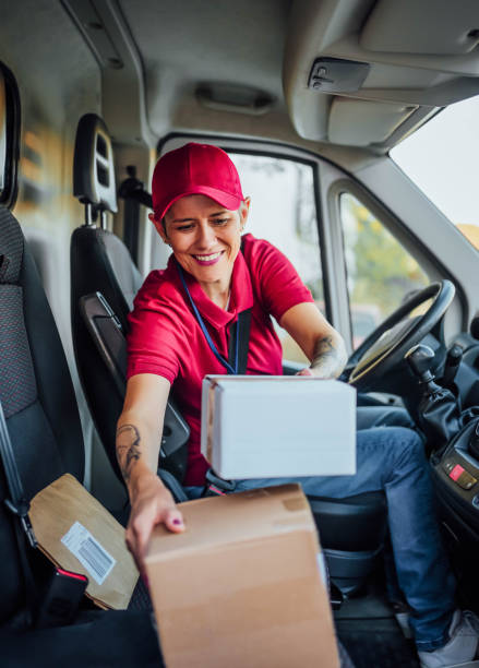 istock Female courier at delivery van 1791591016