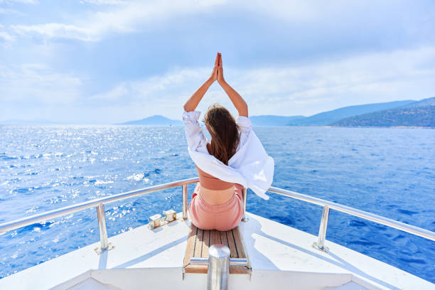 free carefree inspired traveler girl enjoys relaxing and calm private vacay on a white luxury boat in the turquoise sea - sailing light wind nautical vessel imagens e fotografias de stock