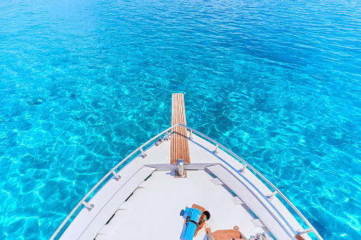 White private luxury boat in turquoise water