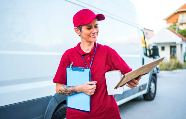 istock Female courier checking address label 1791594683