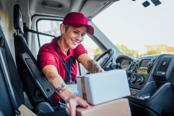 istock Female courier at delivery van 1791595204