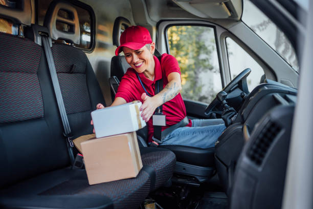 istock Female courier at delivery van 1791595786