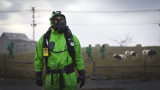 People in protective suits inspecting a desolated rural area