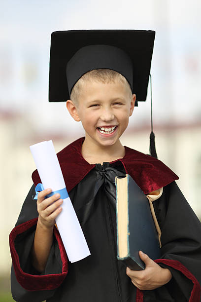 istock Boy graduate with a diploma and books 179160393