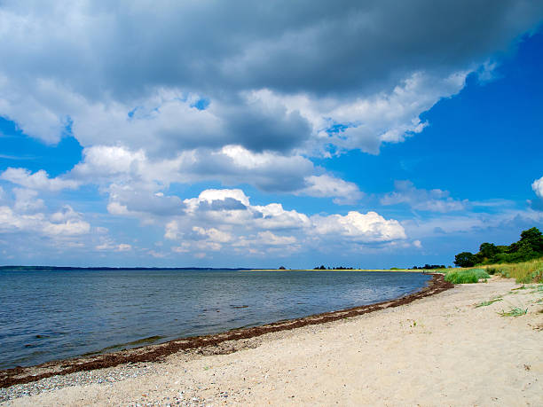istock moody sky and beautiful beach 179160620