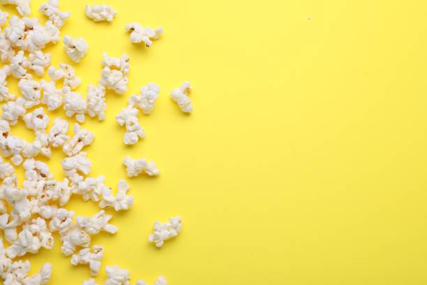 istock Tasty pop corn on yellow background, flat lay. Space for text 1791606368