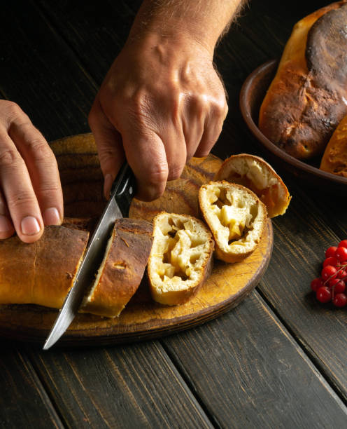 istock A baker slices a fresh pie with apples for serving the holiday table. Delicious apple pie with aromatic tea. 1791614040