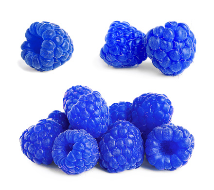 Set with fresh tasty blue raspberries on white background