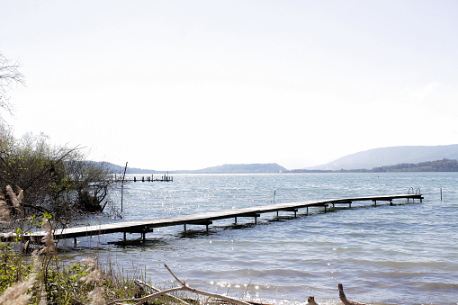 view of a pier at a lake shore in spring