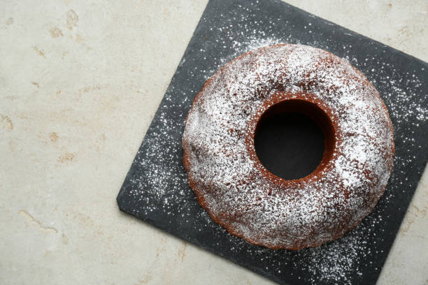 istock Delicious homemade yogurt cake with powdered sugar on gray table, top view. Space for text 1791619016
