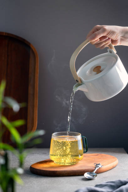 istock Pouring hot green tea into a transparent cup 1791624467