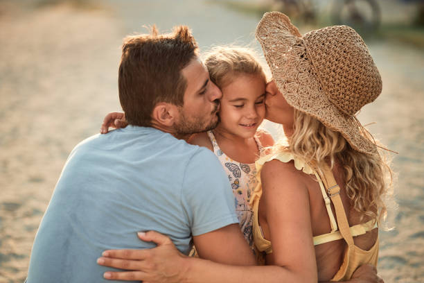 Beautiful family enjoying sunset on a beach vacation.