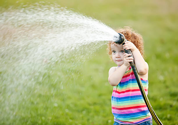 istock Girl Playing With Garden Hose 179164209
