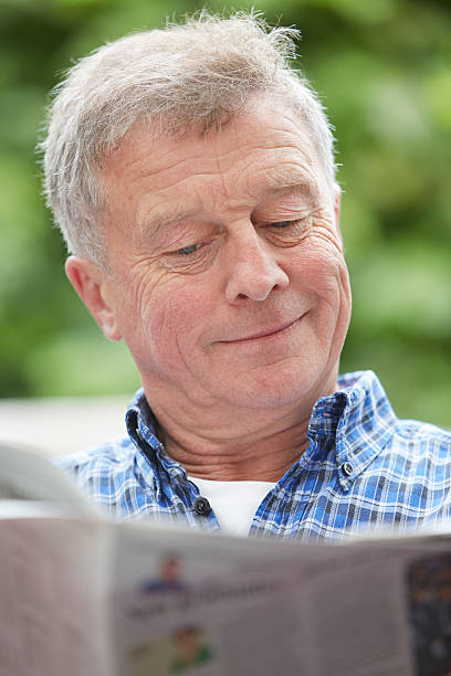 istock Senior Man Reading Newspaper Outdoors At Home 179164932